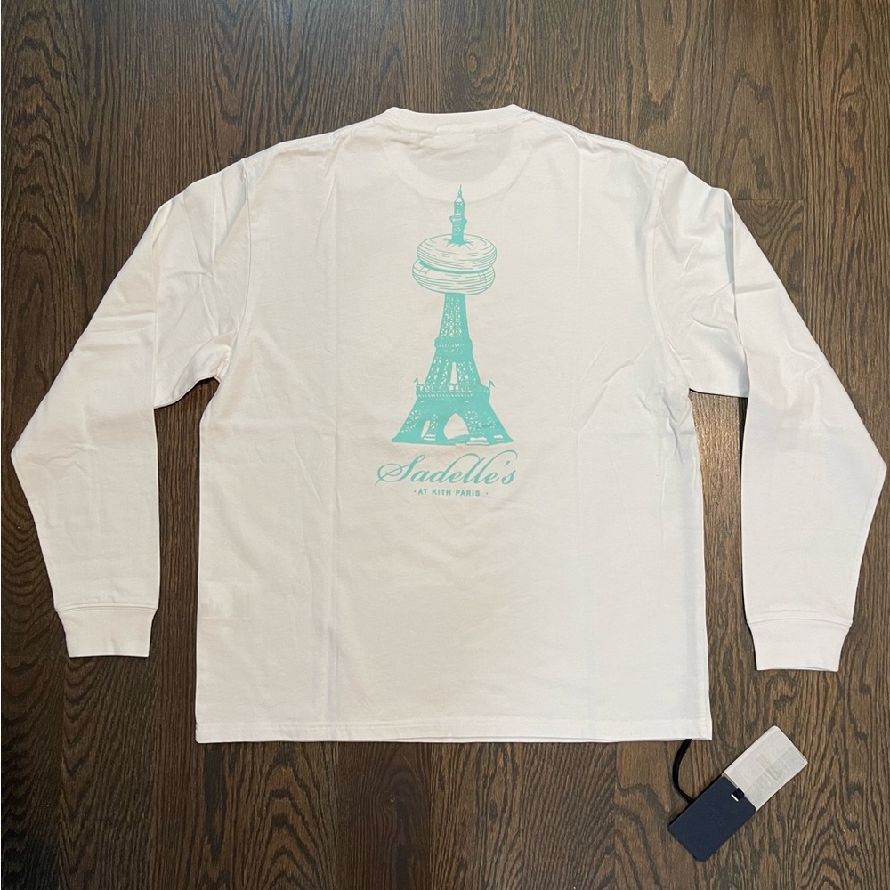 Kith x Sadelle’s Limited Edition White Long Sleeve Tee with Teal Graphic